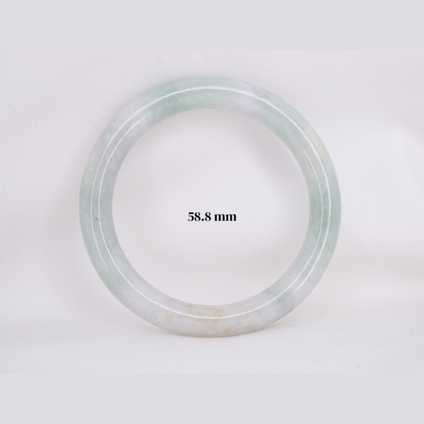 Natural Burmese jade bangle in thin donut shape. Genuine jade bracelet symbolizing protection, harmony, and prosperity. Elegant collectible jewelry gift.