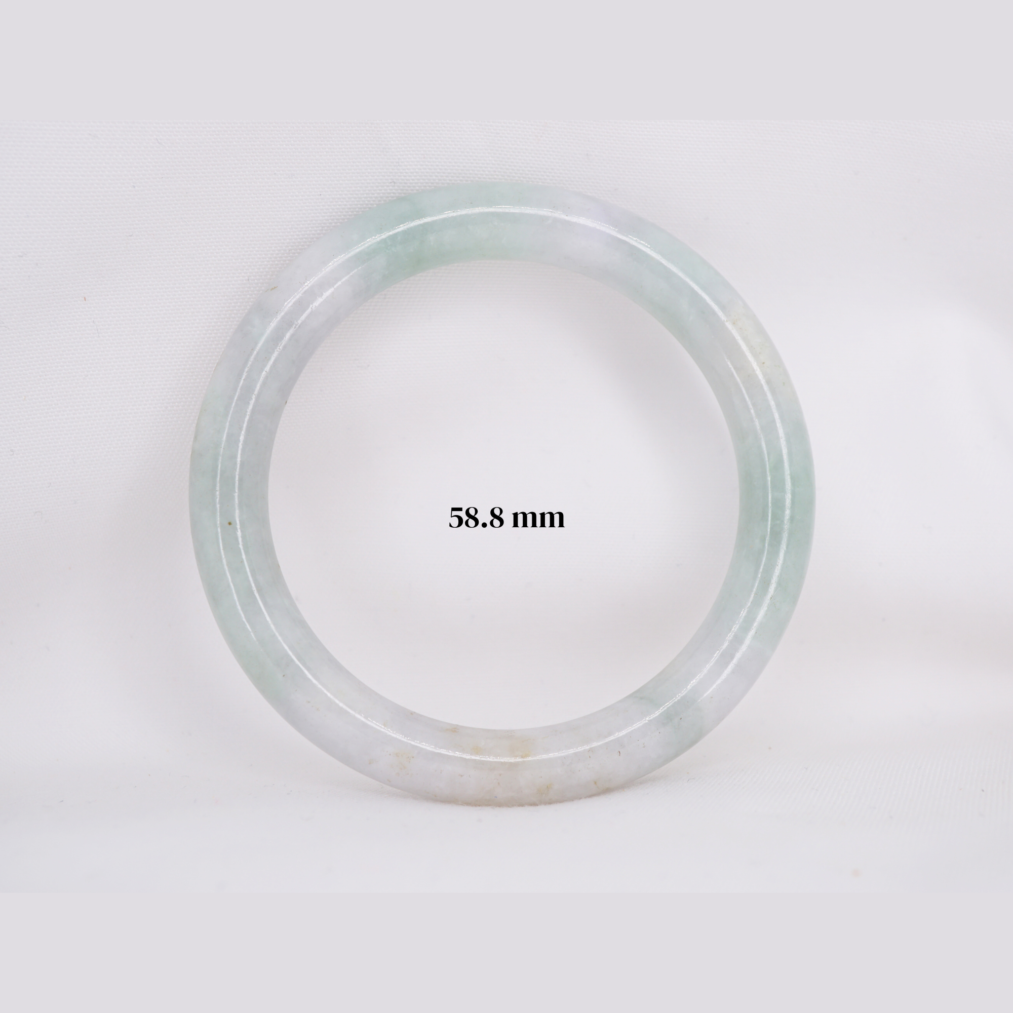 Natural Burmese jade bangle in thin donut shape. Genuine jade bracelet symbolizing protection, harmony, and prosperity. Elegant collectible jewelry gift.