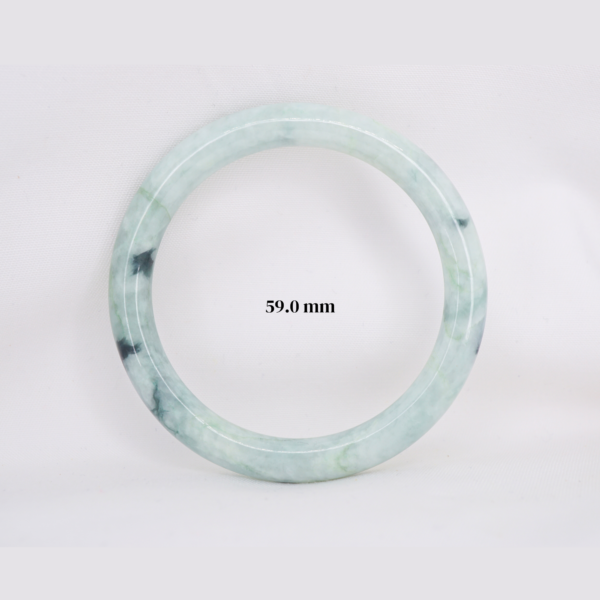 Natural Burmese jade bangle in thin donut shape. Genuine jade bracelet symbolizing protection, harmony, and prosperity. Elegant collectible jewelry gift.
