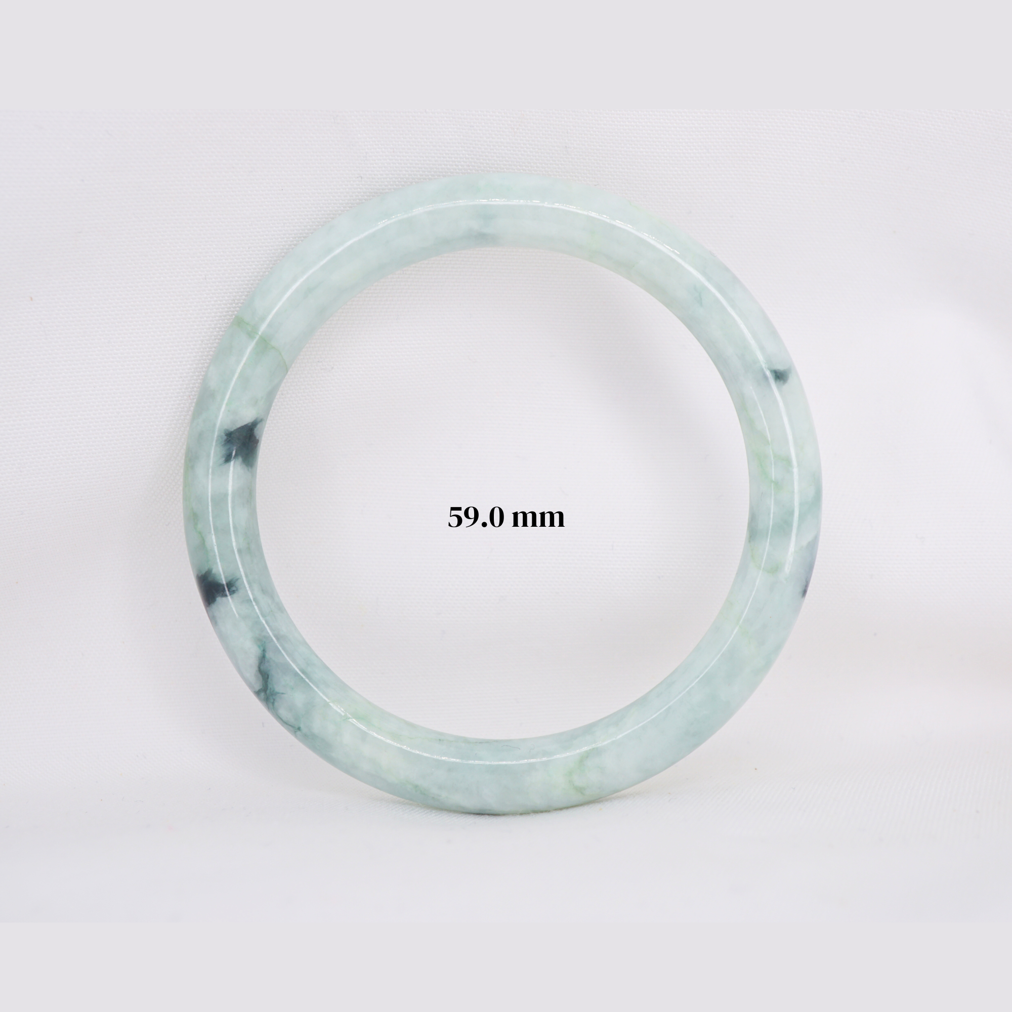 Natural Burmese jade bangle in thin donut shape. Genuine jade bracelet symbolizing protection, harmony, and prosperity. Elegant collectible jewelry gift.