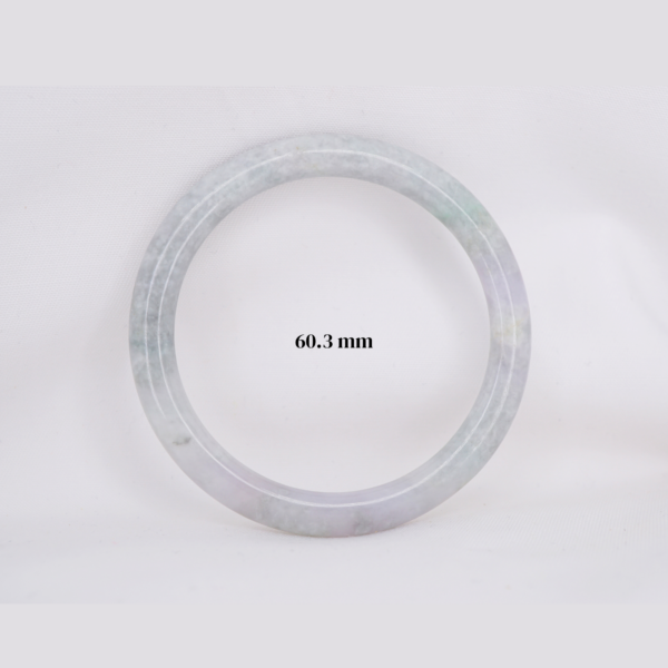 Natural Burmese jade bangle in thin donut shape. Genuine jade bracelet symbolizing protection, harmony, and prosperity. Elegant collectible jewelry gift.