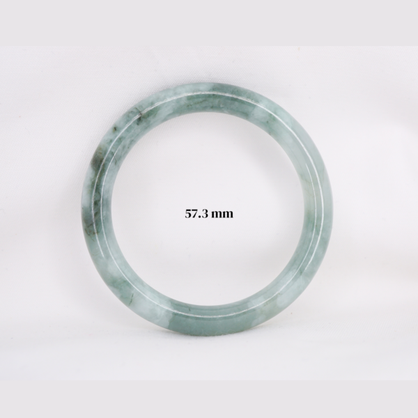 Natural Burmese jade bangle in thin donut shape. Genuine jade bracelet symbolizing protection, harmony, and prosperity. Elegant collectible jewelry gift.
