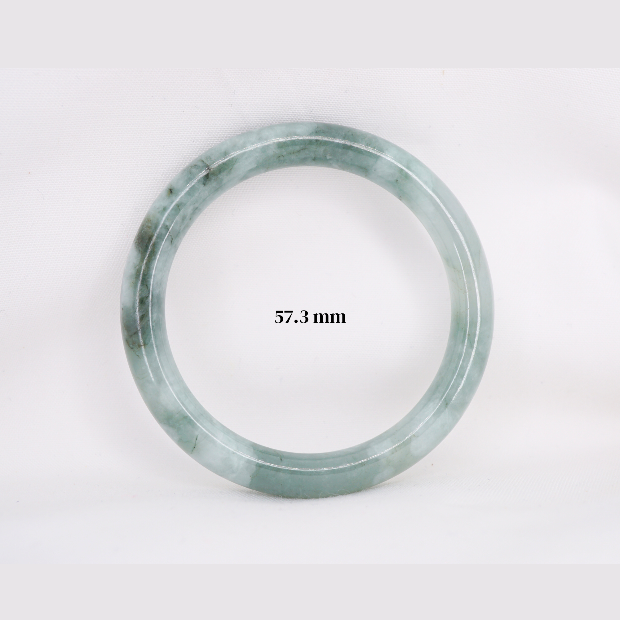 Natural Burmese jade bangle in thin donut shape. Genuine jade bracelet symbolizing protection, harmony, and prosperity. Elegant collectible jewelry gift.
