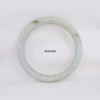 Natural Burmese jade bangle in thin donut shape. Genuine jade bracelet symbolizing protection, harmony, and prosperity. Elegant collectible jewelry gift.
