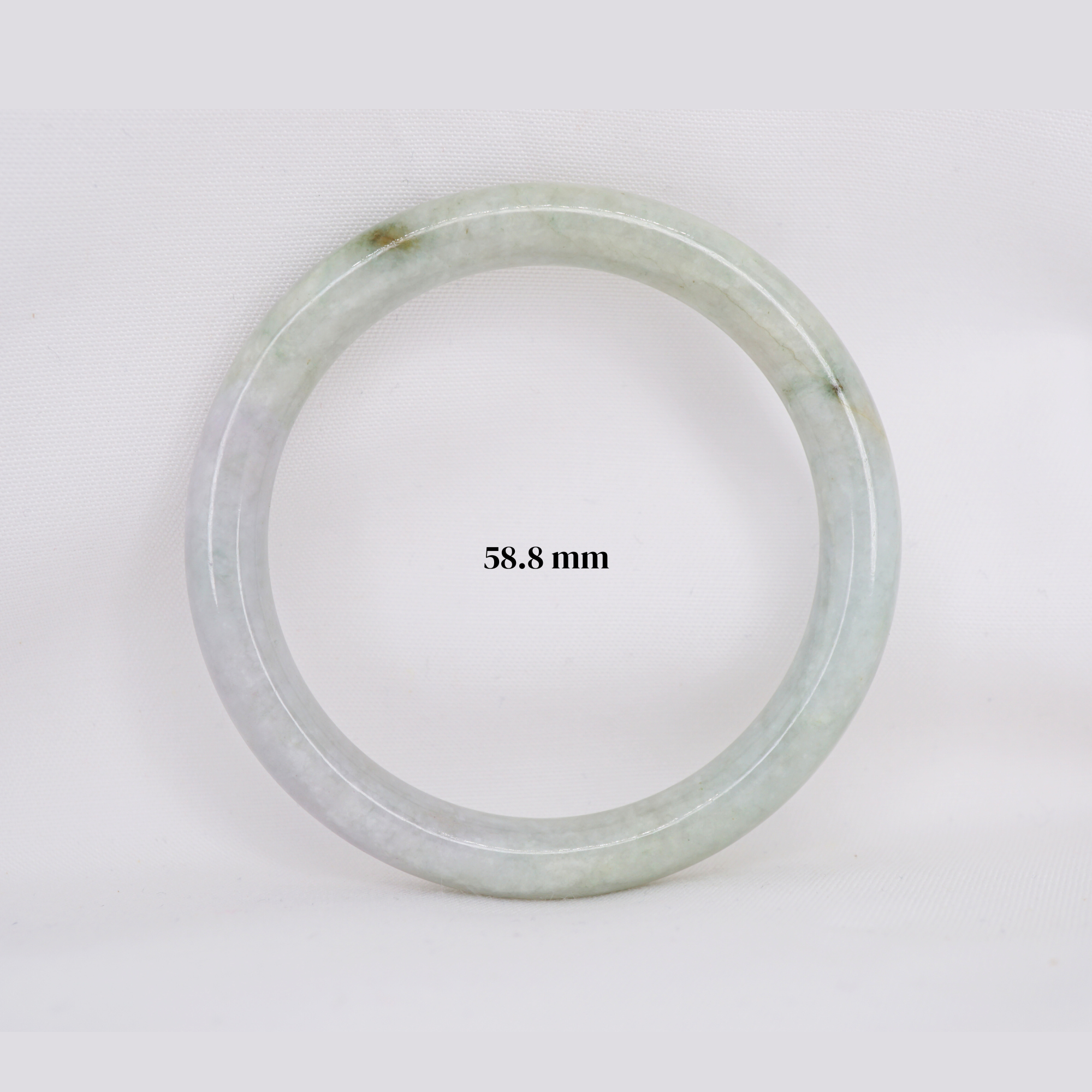 Natural Burmese jade bangle in thin donut shape. Genuine jade bracelet symbolizing protection, harmony, and prosperity. Elegant collectible jewelry gift.