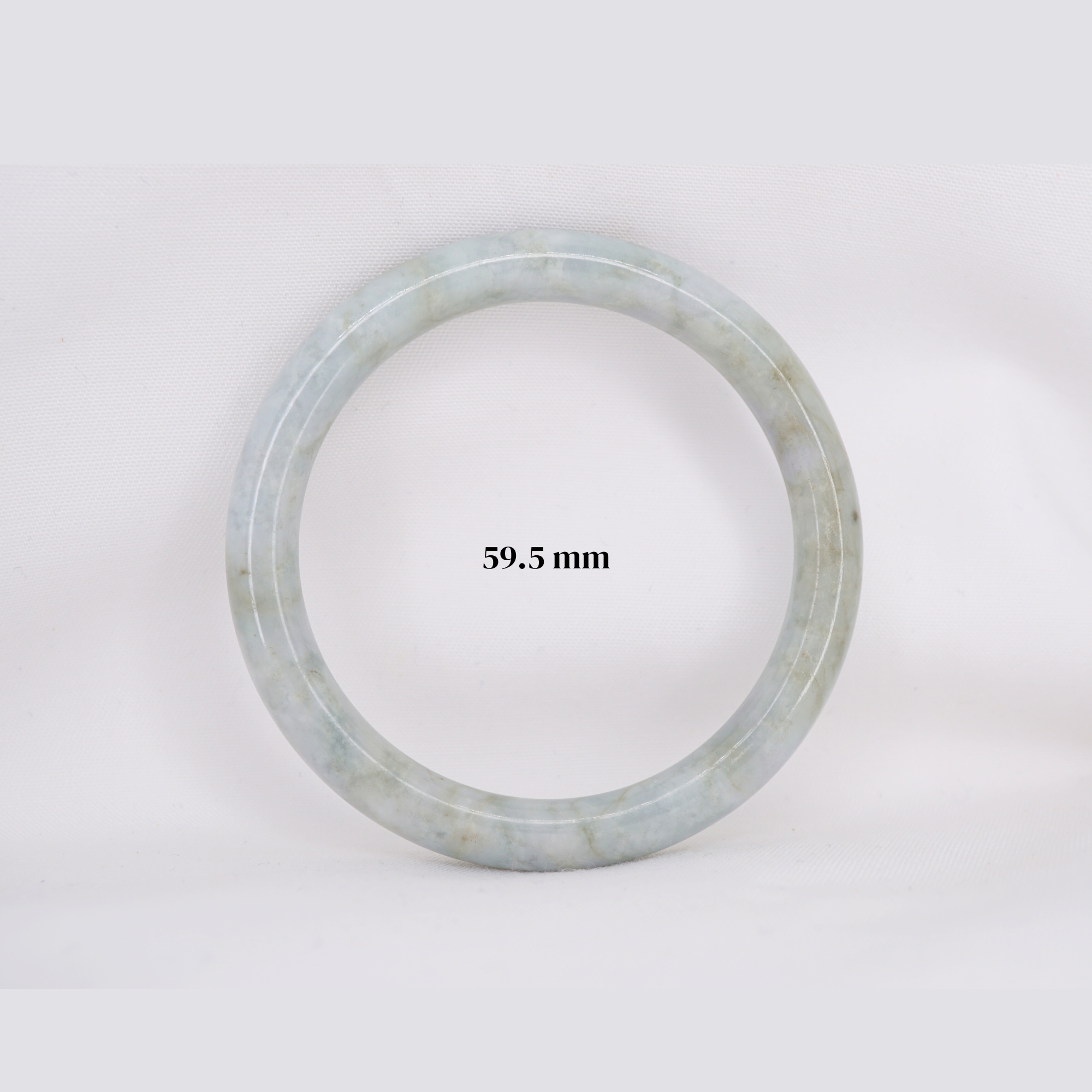 Natural Burmese jade bangle in thin donut shape. Genuine jade bracelet symbolizing protection, harmony, and prosperity. Elegant collectible jewelry gift.