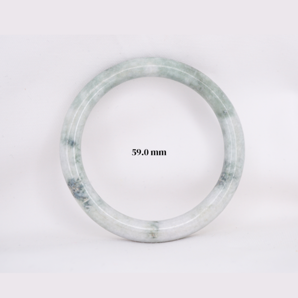 Natural Burmese jade bangle in thin donut shape. Genuine jade bracelet symbolizing protection, harmony, and prosperity. Elegant collectible jewelry gift.