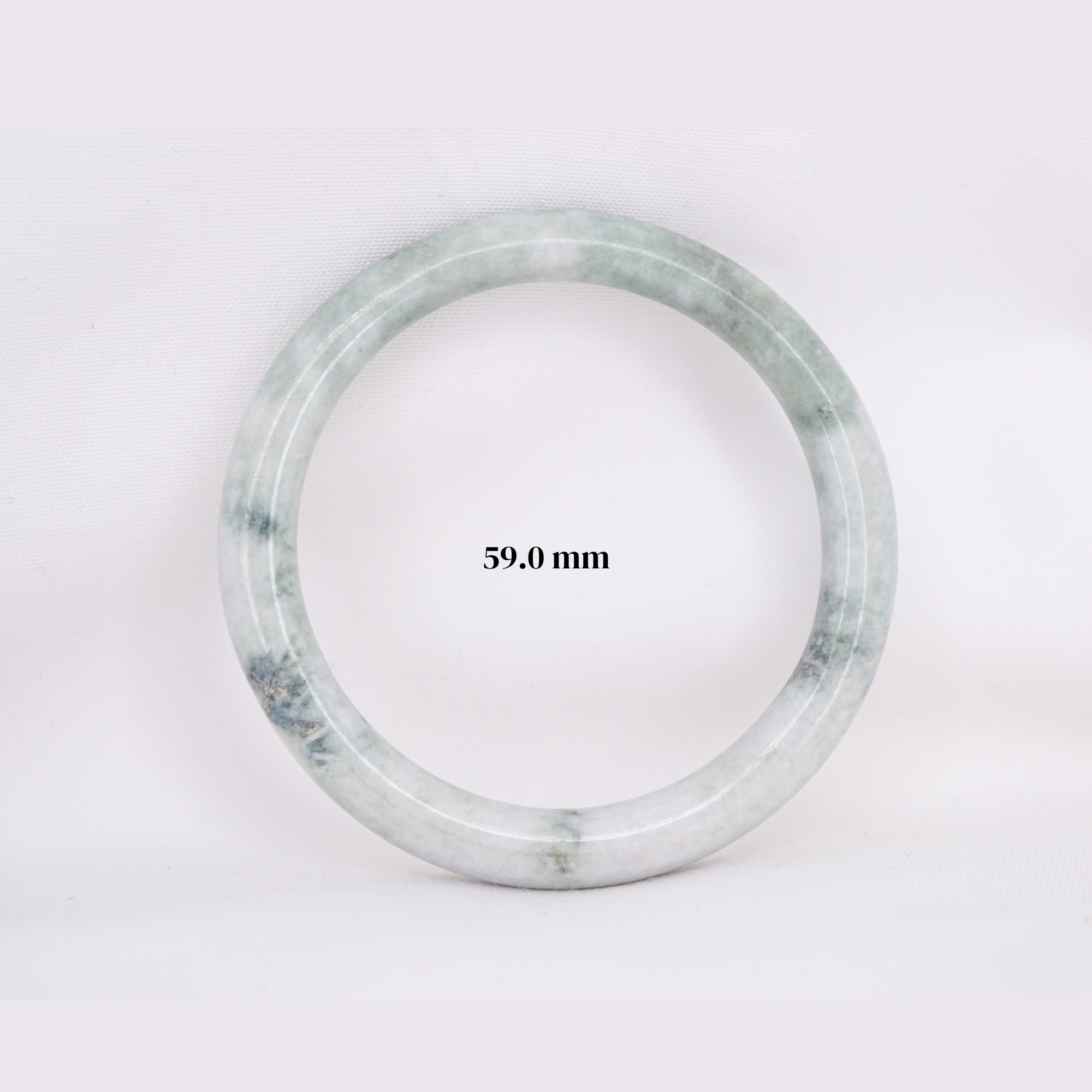 Natural Burmese jade bangle in thin donut shape. Genuine jade bracelet symbolizing protection, harmony, and prosperity. Elegant collectible jewelry gift.