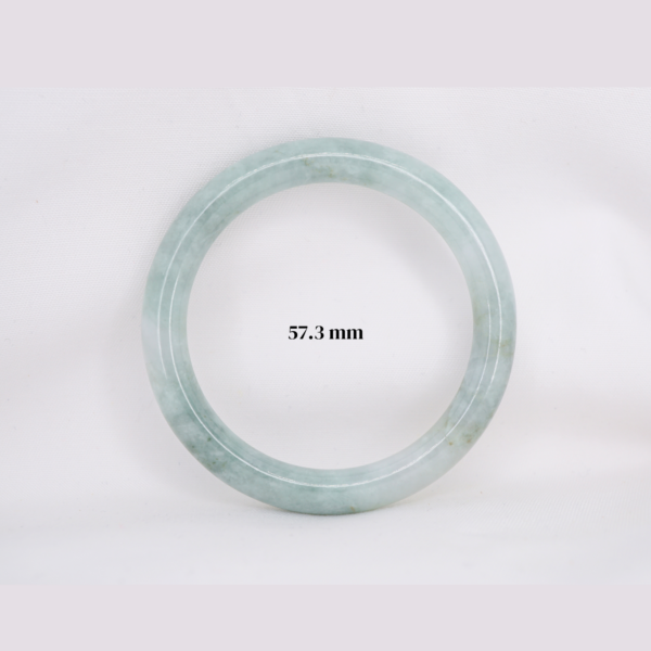 Natural Burmese jade bangle in thin donut shape. Genuine jade bracelet symbolizing protection, harmony, and prosperity. Elegant collectible jewelry gift.