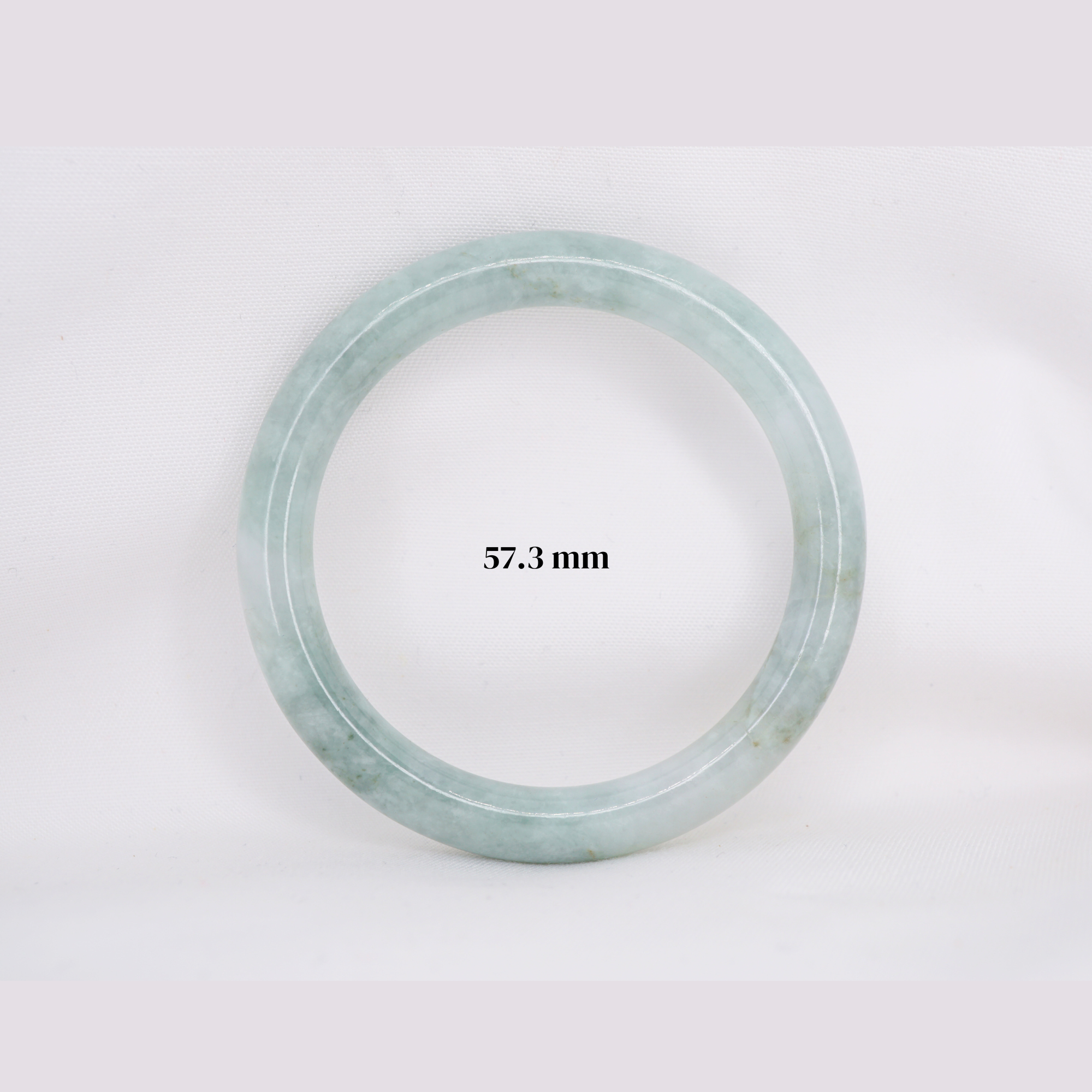 Natural Burmese jade bangle in thin donut shape. Genuine jade bracelet symbolizing protection, harmony, and prosperity. Elegant collectible jewelry gift.